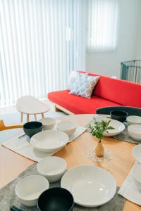 a table with white plates and bowls on it at 藤乃宿 ペットと暮らすように泊まる宿 in Sapporo