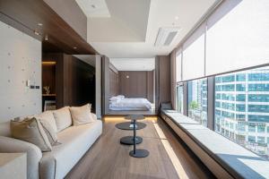 a living room with a couch and a large window at The Moor in Busan +71 photos