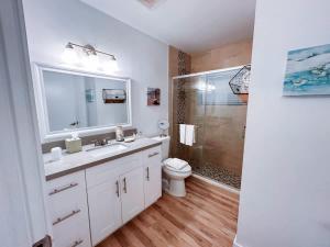 a bathroom with a sink and a toilet and a shower at Beach Getaway One Block from the Beach in Pompano Beach