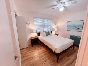 a bedroom with a bed and a ceiling fan at Beach Getaway One Block from the Beach in Pompano Beach +10 photos