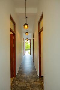 an empty hallway with a hallway leading to a door at Happy Corner Ahangama in Midigama West +10 photos