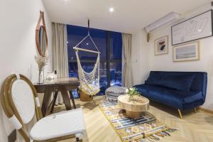a living room with a blue couch and a table at Macaron in Zhangjiajie