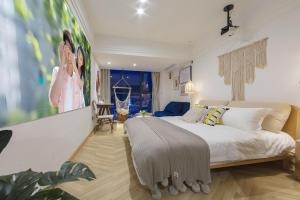 a bedroom with a large bed in a room at Macaron in Zhangjiajie