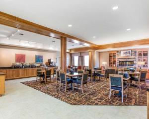 a restaurant with tables and chairs in a room at MainStay Suites Sidney - Medical Center in Sidney