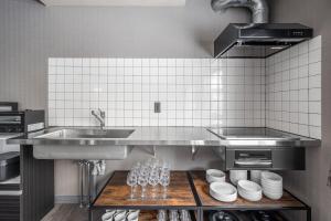 a kitchen with a sink and a counter with wine glasses at The Lavenridge in Nakafurano +35 photos