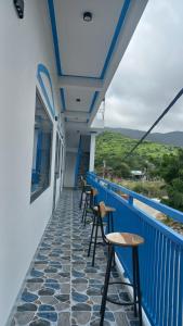 a balcony with chairs and tables on a building at Homestay xóm nhỏ in Ninh Hải