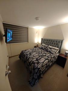een hotelkamer met een bed en een televisie bij Cómodo alojamiento 3D 1B excelente ubicacion in Temuco