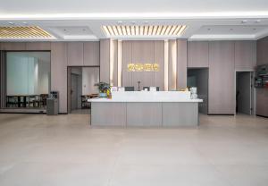 a lobby with a reception desk in a building at Ancient City District Ai Shan Hotel in Lijiang