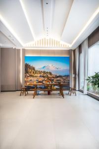 a large room with a large painting on the wall at Ancient City District Ai Shan Hotel in Lijiang