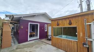 a purple house with a pool in front of it at Casa com jacuzzi in Florianópolis