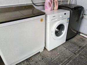 a washing machine sitting next to a washer at Ancient City District Ai Shan Hotel in Lijiang