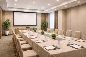 ein großer Tagungsraum mit einem langen Tisch und Stühlen in der Unterkunft 绿色半岛酒店 in Bồ Sơn + 32 Fotos