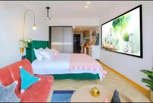 a bedroom with a large bed and a tv at Macaron in Zhangjiajie