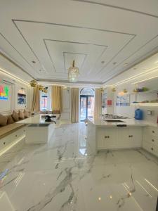 a large white kitchen with a large marble floor at PKseahome 3 bedroom 4 toilet Novaworld in Phan Thiet