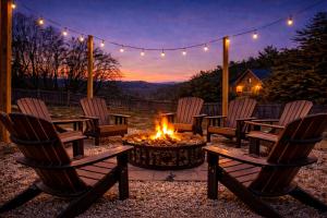 Een groep stoelen rond een vuurplaats met de zonsondergang op de achtergrond. bij King Beds, Views, EasyRoads, PoolTable, Spa, Theater, Outdoor fun in Sevierville