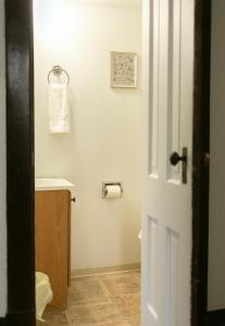 a bathroom with a white toilet and a sink at Charming Spacious 3BR Pet-Friendly Retreat in Billings