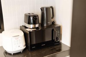 a coffee maker sitting on top of a microwave at Rivla A Pool Villa in Ao Nang 