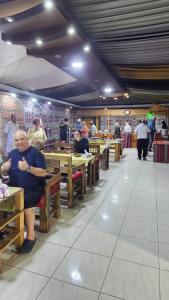 a group of people sitting at tables in a restaurant at Bubble RumCamp in Wadi Rum