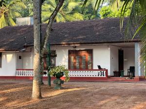 a white house with a red and white porch at WIJAYA Rest in Gampaha