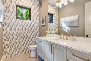 a bathroom with a toilet and a sink and a mirror at BELL115*: Bellevue Splendor in Bellevue +73 photos