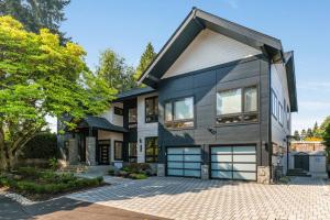 a house with two garage doors on a brick driveway at BELL115*: Bellevue Splendor in Bellevue