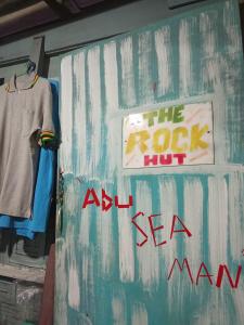 a wall with a sign for the rock butayn mannequins at Easy Life Hut in Ko Bu Bu