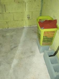 a yellow basket sitting next to a brick wall at Easy Life Hut in Ko Bu Bu