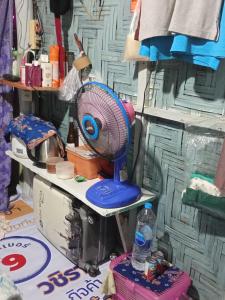 a blue fan sitting on top of a table at Easy Life Hut in Ko Bu Bu +5 photos