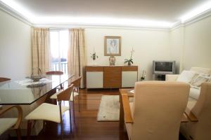 a living room with a couch and a dining room at Helen´s House Apartment in Câmara de Lobos