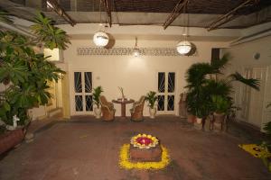 a room with a table with flowers and potted plants at Bagru Haveli in Jaipur