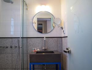 a bathroom with a sink and a mirror at Bezalel Hotel - an Atlas Boutique Hotel in Jerusalem
