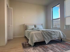 a bedroom with a bed and a large window at Luxury 12 Bedroom Villa in Denton