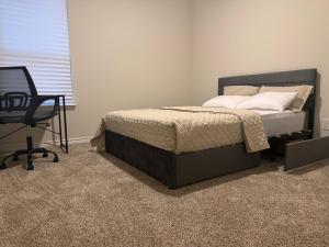 a bedroom with a bed and a desk and a chair at Luxury 12 Bedroom Villa in Denton