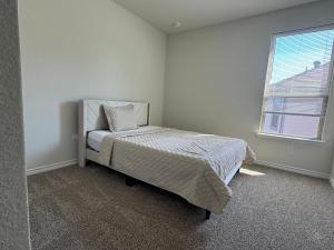 a bedroom with a bed and a window at Luxury 12 Bedroom Villa in Denton +12 photos