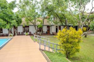a house with a pool and a fence at Flamingo Lake Resort Tissamaharama in Modakandiya +58 photos