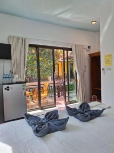a bedroom with two blue bows on a bed at LANTA LUCKY HOUSE in Ko Lanta