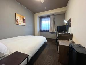 En eller flere senge i et værelse på Hotel Route-Inn Susono Inter