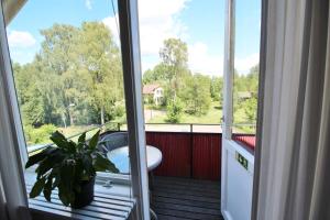 a door to a balcony with a car on a porch at Orrefors hotell & restaurang in Nybro
