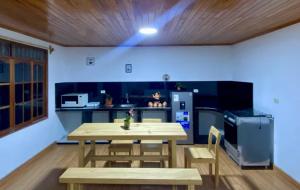 a kitchen with a table and chairs and a refrigerator at Casa de Campo in Chontabamba