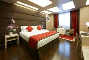 a bedroom with a large bed with a red blanket at Harry's Bar Trevi Hotel & Restaurant in Rome