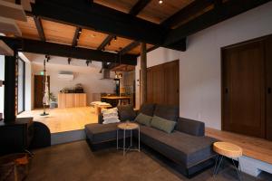 a living room with a couch and a table at ひのまきbase-暖- in Uda