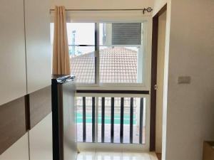 a large window in a room with a balcony at Grandview Ladprao Hotel in Bangkok