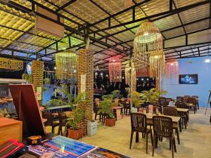 a restaurant with tables and chairs and chandeliers at Top Views Retreat in Koh Rong Island