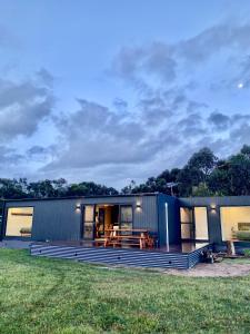 a modular home with a deck and a house at Grampians View Eco Retreat in Halls Gap