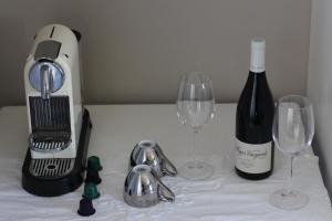 a blender and two wine glasses on a table at Seaside Hermanus Guest Room in Hermanus
