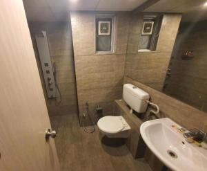 a small bathroom with a toilet and a sink at Magiical weekend in Surat