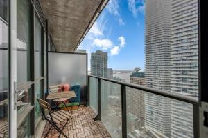 a balcony with a view of a city skyline at Luxe 3-Bedroom Lakeview Condo, Free parking ,Walk to CN Tower, Scotiabank Arena & Rogers Centre in Toronto