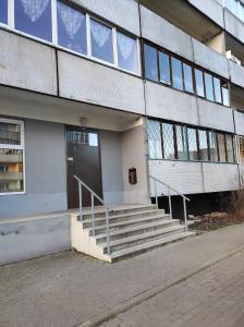 a building with a staircase leading to a door at Laima in Riga