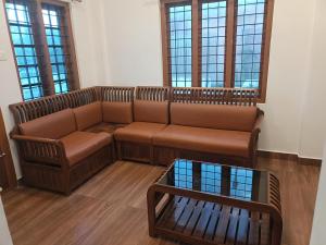 a living room with a couch and a table at Eva homes in Vagamon