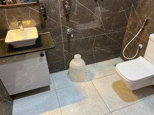 a bathroom with a toilet and a sink at The Dritan Brookefield ITPL Main Road in Bengaluru +38 photos
